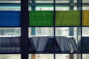 color-coded journals on shelves